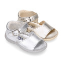 Metal finish leather sandals with buckle fastening and super flexible soles for little girls.
