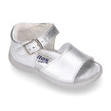 Metal finish leather sandals with buckle fastening and super flexible soles for little girls.