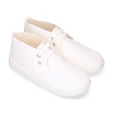 Cotton canvas Wallabee style bootie shoes with ties closure.