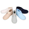 Cotton canvas Wallabee style bootie shoes with ties closure.