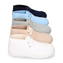 Cotton canvas Wallabee style bootie shoes with ties closure.