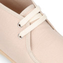 Cotton canvas Wallabee style bootie shoes with ties closure.