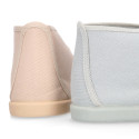 Cotton canvas Wallabee style bootie shoes with ties closure.