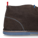 Suede leather ankle boots Oxford style with shoelaces and outsole in contrast.