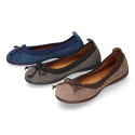 Suede leather ballet flat shoes with elastic band and perforated design.