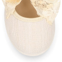 Linen Girl Mary Jane shoes with hook and loop strap closure with bow with lace design.