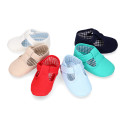 Cotton canvas T-strap shoes with hook and loop strap for babies.