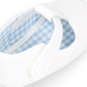 Cotton canvas T-strap shoes with hook and loop strap for babies.