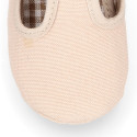 Cotton canvas T-strap shoes with hook and loop strap for babies.