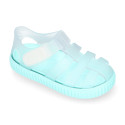 Tennis style kids jelly shoes with hook and loop strap and soles in colors.