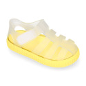 Tennis style kids jelly shoes with hook and loop strap and soles in colors.