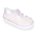 Tennis style kids jelly shoes with hook and loop strap and soles in colors.