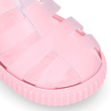 Tennis style kids jelly shoes with hook and loop strap and soles in colors.