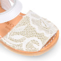 Soft leather Menorquina sandal shoes with pearl effect and laces design.