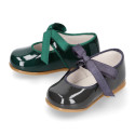 Patent leather little Mary Janes with ties closure.