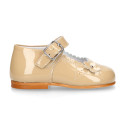 Classic patent leather little Mary Jane shoes with flower detail.