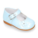 Classic patent leather little Mary Jane shoes with flower detail.