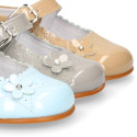 Classic patent leather little Mary Jane shoes with flower detail.