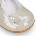 Classic patent leather little Mary Jane shoes with flower detail.