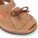 Nubuck leather Menorquina sandal shoes with hook and loop strap and fringed design.