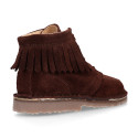 Suede leather ankle boots with fringed and central stitches design.