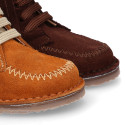 Suede leather ankle boots with fringed and central stitches design.