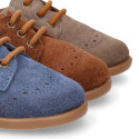 Classic suede leather Laces up shoes with perforated design for autumn.