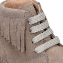 Suede leather ankle desert boots style with fringed design.