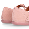 Pink Suede leather T-Bar Girl Mary Jane shoes with buckle fastening and chopped design.