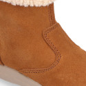 Kids suede leather boots with fur neck design in tan color.
