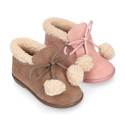 Booties with shoelaces closure with pompons and fake hair neck in suede leather for kids.