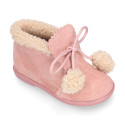 Booties with shoelaces closure with pompons and fake hair neck in suede leather for kids.