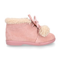 Booties with shoelaces closure with pompons and fake hair neck in suede leather for kids.