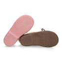 Booties with shoelaces closure with pompons and fake hair neck in suede leather for kids.