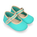 Cotton canvas baby Mary janes with hook and loop strap and buckle fastening.