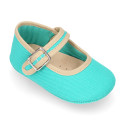 Cotton canvas baby Mary janes with hook and loop strap and buckle fastening.