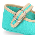 Cotton canvas baby Mary janes with hook and loop strap and buckle fastening.