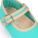 Cotton canvas baby Mary janes with hook and loop strap and buckle fastening.