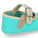 Cotton canvas baby Mary janes with hook and loop strap and buckle fastening.