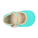 Cotton canvas baby Mary janes with hook and loop strap and buckle fastening.