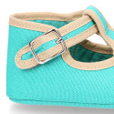 Classic cotton canvas T-Strap shoes for babies with hook and loop strap.