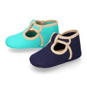 Classic cotton canvas T-Strap shoes for babies with hook and loop strap.