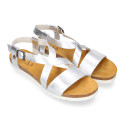 Metal leather sandal shoes for toddler girls with white soles.