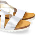 Metal leather sandal shoes for toddler girls with white soles.