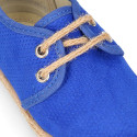 Laces up shoes espadrille style in suede leather canvas effect.