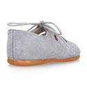 English style kids shoes with shoelaces in suede leather in pastel colors.