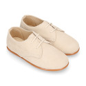 Oxford style kids shoes with shoelaces in suede leather in pastel colors.