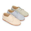 Oxford style kids shoes with shoelaces in suede leather in pastel colors.