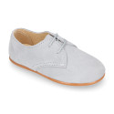 Oxford style kids shoes with shoelaces in suede leather in pastel colors.
