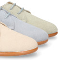 Oxford style kids shoes with shoelaces in suede leather in pastel colors.